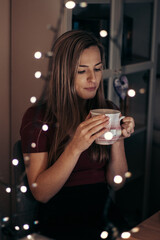 beauty of European ethnicity is enjoying a moment to herself. Thinking about your past and future. The key decision of your life over a cup of tea. Emphasizing the emotional curve