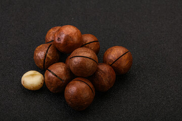 Brown macadamia nut heap over background