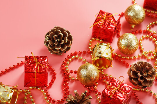 Christmas or new Year pink background with red and gold decorations for Christmas tree with free space.