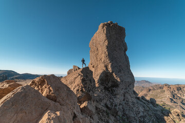 young traveler climbs the roque nublo. Gran Canaria. Canary Islands