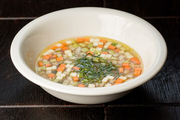 vegetable soup with carrots and zucchini garnished with dill