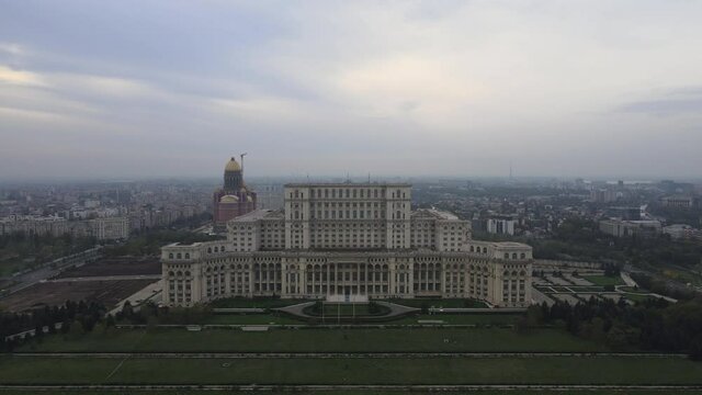 Aerial cityscape Palace of the Parliament, Bucharest communist historical building for the Parliament of Romania, central administration landmark tourism monument. Communism history sunset skyline