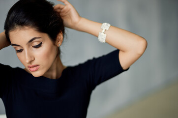 Fototapeta premium attractive brunette lady with a decoration on her hand and in an evening dress on a gray background