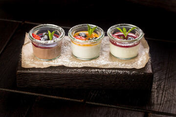 assorted panna cotta with jam decorated with fruit