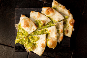 sliced delicious Italian focaccia with pesto sauce