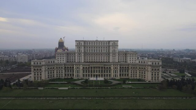 Palace of the Parliament, aerial drone shot in Bucharest communist historical building for Parliament of Romania central administration landmark tourism monument. Communism history sunset skyline
