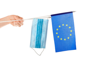 EU flag and medical mask on white background