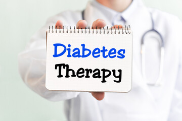 Doctor holding a card with text DIABETES THERAPY medical concept