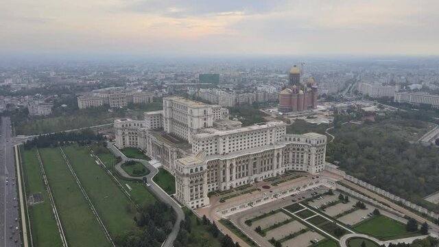 Palace of the Parliament, aerial drone cityscape Bucharest historical communist building for Parliament of Romania central administration landmark tourism monument. Communism history sunset skyline