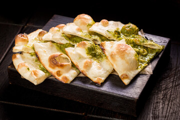 sliced delicious Italian focaccia with pesto sauce
