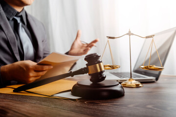 justice and law concept.Male judge in a courtroom on wooden table and Counselor or Male lawyer working in office. Legal law, advice and justice concept.