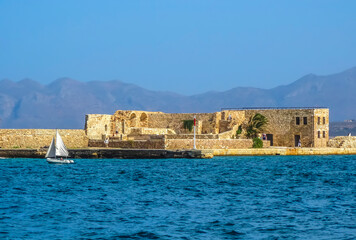 Fototapeta na wymiar A view of the harbour breakwater defenses in Chania, Crete on a bright sunny day