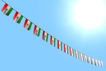 nice national holiday flag 3d illustration. - many Iran flags or banners hanging diagonal on string on blue sky background with bokeh