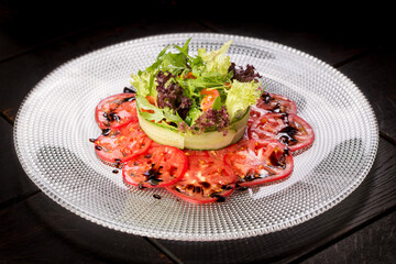 Salad with crab and avocado on tomato carpaccio