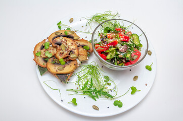Sandwich with fried mushrooms, basil, pumpkin seeds and microgreens - radish and onion seedlings and tomato and cucumber salad, served with sesame seeds.