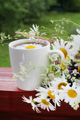 A cup with floral natural chamomile tea	