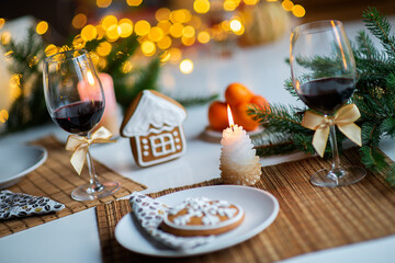 festive Christmas mood with a glass of wine and a burning candle on the kitchen dinner table