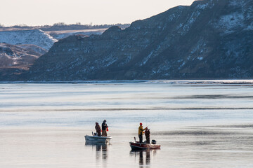 Fishing from boats on the Missouri River in the winter