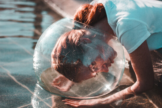 The girl has an aquarium on her head. Portrait