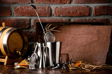 Steel bar tools for making cocktail. Shaker, jigger, strainer, Set of bar accessories on wooden background with copy space