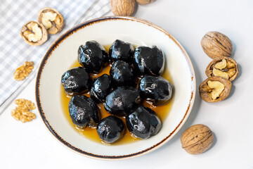 Handmade jam made from green fresh walnuts. Organic walnut jam and walnuts.