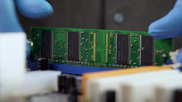 High tech. The process of installing RAM on a computer motherboard. Close-up 4K