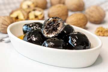 Handmade jam made from green fresh walnuts. Organic walnut jam and walnuts.