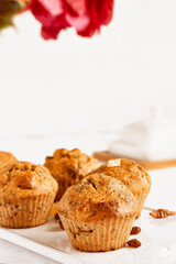 Homemade muffins with ginger and nuts on white table. Healthy eating, gluten free.Homemade tasty dessert or breakfast for Valentine's day,Mother's day