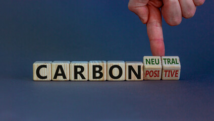From carbon positive to neutral. Hand flips cubes and changes words 'carbon positive' to 'carbon...