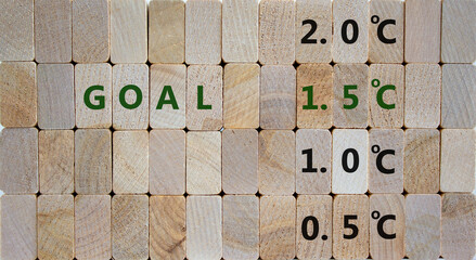 Symbol for limiting global warming. Wooden blocks with word 'Goals 1.5 C'. 0.5 C, 1.0 C, 2.0 C numbers. Beautiful wooden background, copy space. Business and limiting global warming concept.