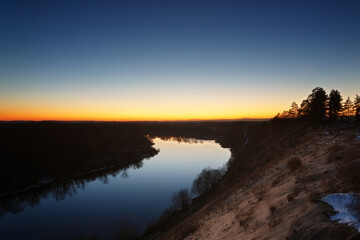 View of the river from the cliff. Evening sky after sunset.