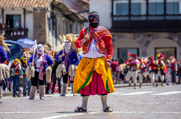 Peru, Cuzco, traditional dances for the Easter Parade on the Plaza de Armas. Dancer wear colourful costumes and head covers.