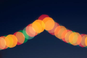 Festive multicolored bokeh. Dark background and multicolored circles.