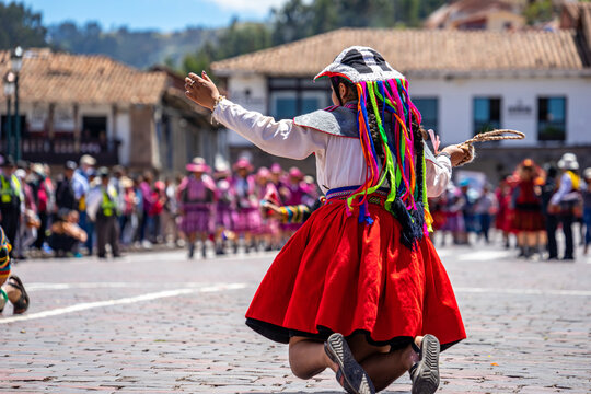 Peru, Cuzco, traditional dances for the Easter Parade on the Plaza de Armas. Dancer wear colourful costumes and head covers.