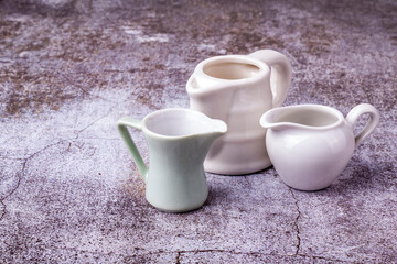 Three portion jugs for cream or milk on the table