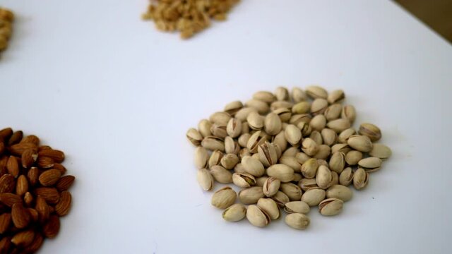 Groups of nuts and seeds on a white table