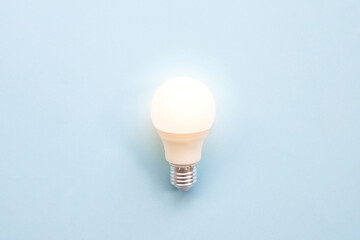  light bulb on a blue paper background