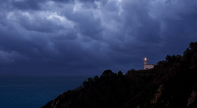 Dark clouds over the Igueldo lighthouse, Euskadi