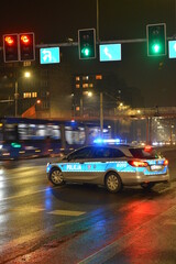 Radiowóz policyjny na sygnale nocą. 