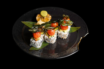 Sushi on a black art plate and black background