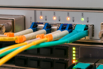 Fiber optic cable are connected to the interfaces of the central router. Modern equipment of the...