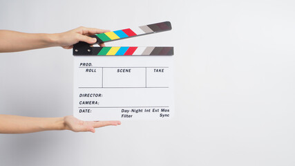 Two Hand is holding clapperboard or movie slate.It 's used in video production and cinema ,film industry on white background. - obrazy, fototapety, plakaty