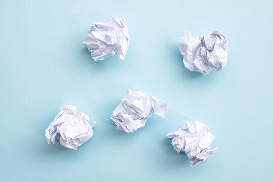 Crumpled paper balls on a blue background	