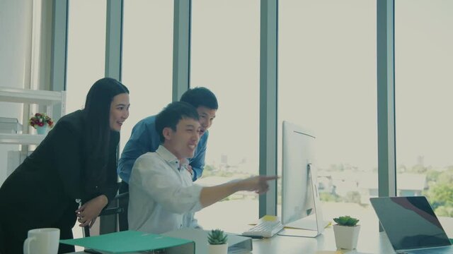 Business concept of 4k Resolution. The team is delighted with the success of the project in the office.