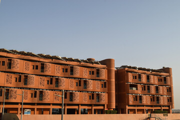 Facade of Masdar Institute Campus, in Masdar City, in contrast with the blue sky. Abu Dhabi, United Arab Emirates.