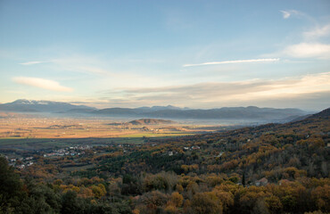 Natural landscape with trees, mountains and some houses, on a cold day, Lazio, Italy.