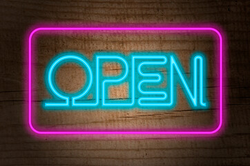 sign with the bright caption open, neon with dark wood background