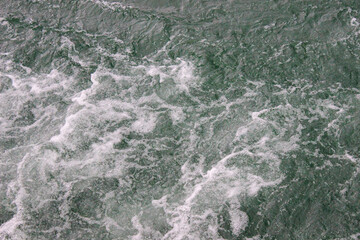 Waves on the water of the lake that appeared after the motorboat