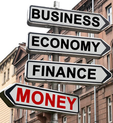 Obraz premium The road indicator on the arrows of which is written - business, economics, finance and MONEY