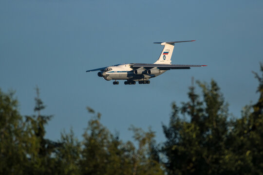 Moscow , Vnukovo, Russia - July 04, 2020: Russian cargo jet airplane Ilyushin Il-76 landing at the airport flying over the tops of green trees
